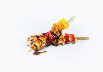 Japanese Calamari Skewers with bell pepper served with sauce. Yakitori Calamari isolated on white background. Pan Asian dish isolation. Kusiyaki seafood with paprika 