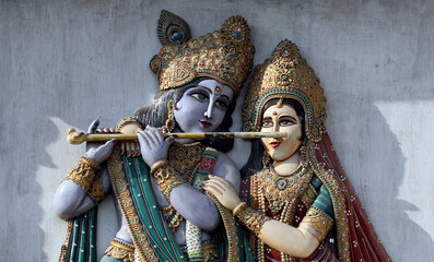 Closeup of Krishna and Radha wooden carving In a temple