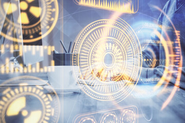 Fototapeta premium Technology theme hologram with man working on computer on background. High tech concept. Double exposure.