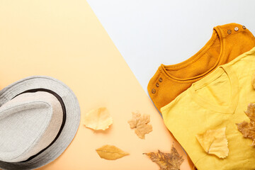 Sweaters with hat and autumn leafs on paper background
