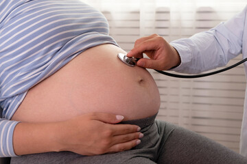 Pregnant woman at doctor's office for the regular check up. Cropped shot of unrecognizable female...