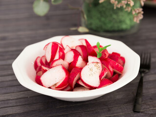 cooked crispy radish in white bowl on wooden table