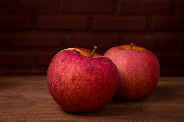 A bright red apple on a wooden table