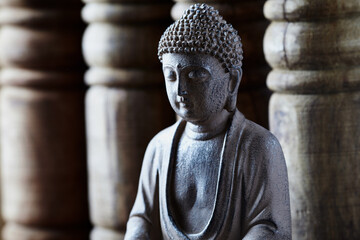 Meditating Buddha Statue on bright background. Close up.