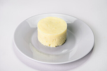 Mashed potatoes on gray plate served in culinary ring. Restaurant food menu garnish isolation on gray background. Warm Side dish.
