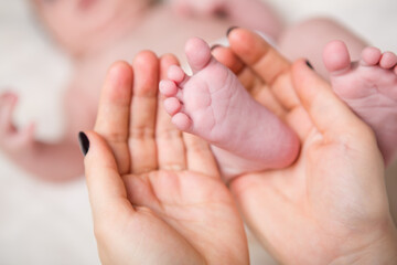 Baby foot in mothers hands