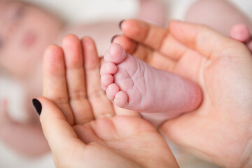 Baby foot in mothers hands
