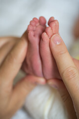 Baby foot in mothers hands