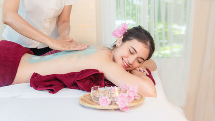 Obraz na płótnie Canvas Spa Massage. Masseur doing massage with treatment sugar scrub on Asian woman body in the Thai spa lifestyle, Young beauty people relaxation for body massage. 