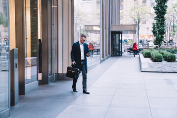 Businessman coming out from office building