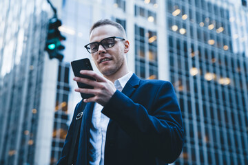 Businessman texting on phone in downtown