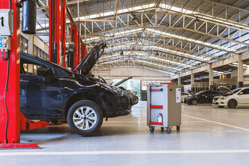 Fototapeta premium car in automobile repair service center with soft-focus and over light in the background