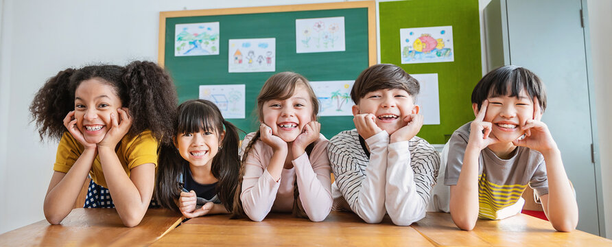 Portrait of five children having good time in classroom, asian caucasian children together in school background. Home school education, diversity multicultural community. Back to school concept