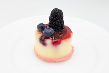 Small Berry Cheesecake on a White Plate with a White Background