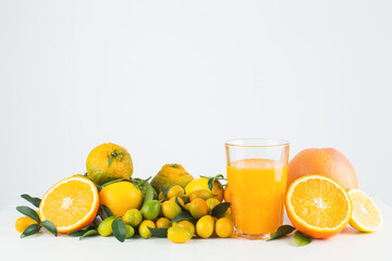 Citrus fruits and glass of orange juice