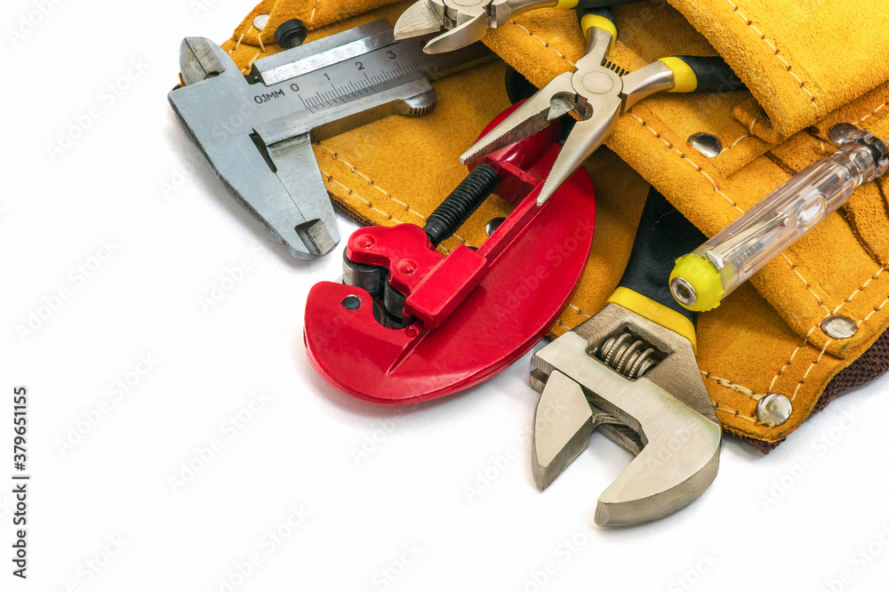 Wall mural Set of tools for the builder or plumber in bag on a white background. The idea of preparing master before work