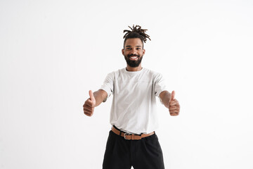 Photo of joyful african american guy showing thumbs up