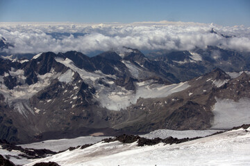 Climbing Elbrus. A view from the slopes of Elbrus to the surrounding mountain peaks covered with snow.