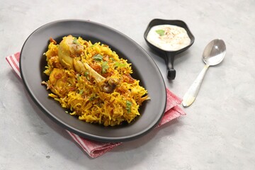 Chicken Biryani/murg Pulao.  Garnished with fried onion & chopped coriander. Biryani raita is a famous Spicy non vegetarian dish of India. Chicken cooked along with Basmati rice & spices. copy space.