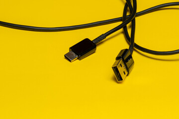 mobile phone charger cable, isolated on yellow background