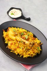 Chicken Biryani/murg Pulao.  Garnished with fried onion & chopped coriander. Biryani raita is a famous Spicy non vegetarian dish of India. Chicken cooked along with Basmati rice & spices. copy space.