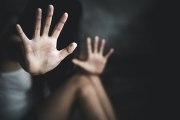 Woman's hand extended signaling to stop useful to campaign against violence, gender or sexual discrimination