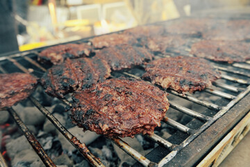 Barbecue in the backyard. Grilled burgers. Fried meat on coals. American traditions.