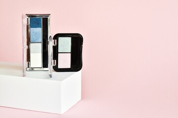 Palette on eyeshadow make up on a pink background.Decorative cosmetics kit. Cosmetic products on a pink background. 