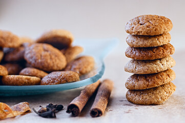 Baked spicy ginger bread sweet cookies with cloves and cinnamon sticks in stack