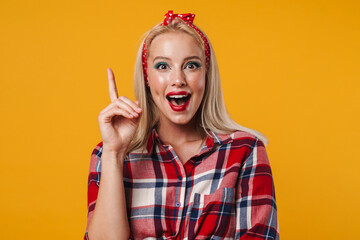 Image of excited blonde pinup girl pointing finger upward