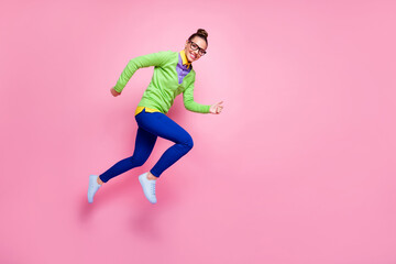 Fototapeta na wymiar Full length profile side photo of cheerful lady girl jump run fast hurry want high school education discount wear green shirt blue pants trousers isolated pastel color background