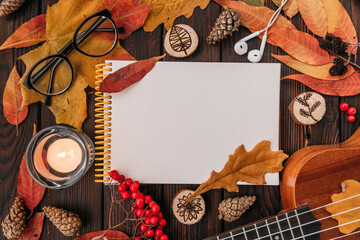 Flat lay. Textured. Autumn leaves,candles on wooden background . Autumn or Winter concept. autumn layout on the wooden table with space for an inscription with glasses falling cones