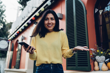 Surprised Asian woman with smartphone in hand