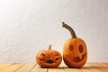 Two pumpkins on wooden table. Halloween and autumn food background