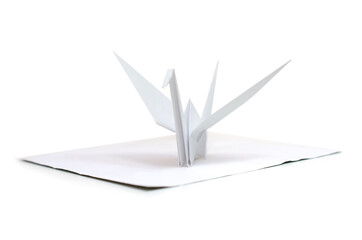 A white origami bird with sheet paper