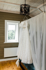 wedding dress hanging inside the room