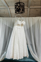 wedding dress hanging inside the room