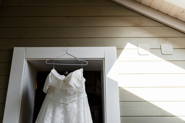 wedding dress hanging inside the room