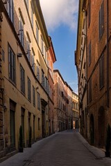 Fototapeta na wymiar Narrow street at the old town of Siena, Tuscany Region in Italy