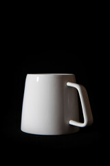 White cup isolated on the black background