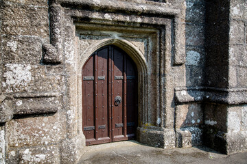 Fototapeta na wymiar Old Norman Church Door with Iron rivets and a Stone Arch