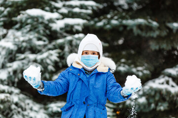 Fototapeta na wymiar Concept of coronavirus COVID-19. Schoolgirl wearing medical face mask to health protection from influenza virus. outdoors portrait. Child back to to school.