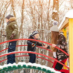 Winter holidays. Kids having fun at winter playground