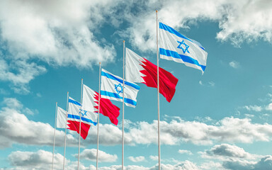 Bahrain and Israel Flags waving against a cloudy sky background. Bahrain–Israel signing historic diplomatic deal. Jerusalem and Manama relations 2020. 
