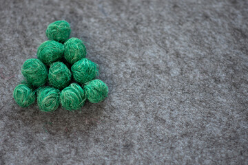 tree made of green textured balls on a gray background