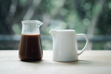 Hot Mocha coffee in transparent glass served with fresh milk or syrup