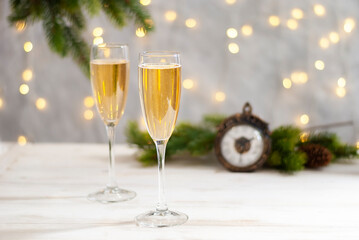 Pair glass of champagne. New year celebration and christmas. Clocks and fir tree branches on the background