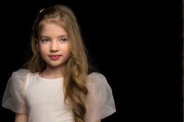 Close-up.Portrait of a cute little girl on a black background.