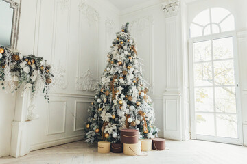 Classic christmas New Year decorated interior room New year tree. Christmas tree with gold...