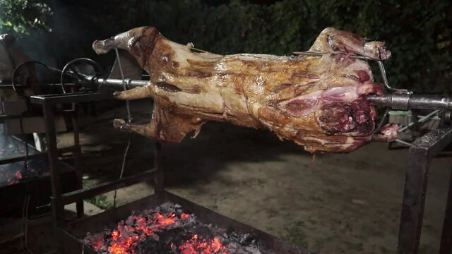 Whole lamb barbeque roasting slowly